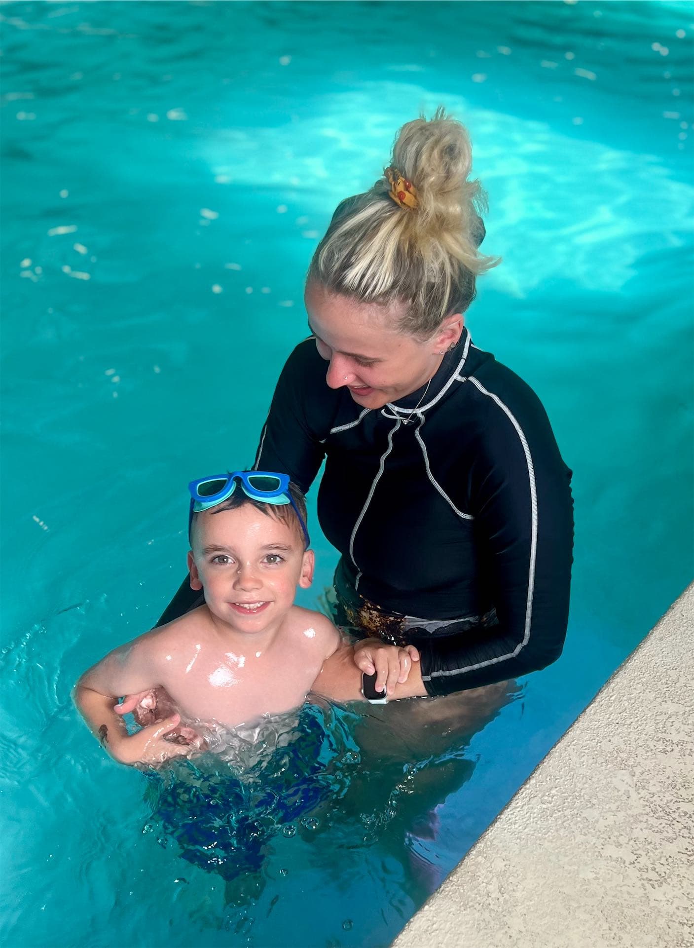 Like a Fish swim instructor coaching a young child in the pool